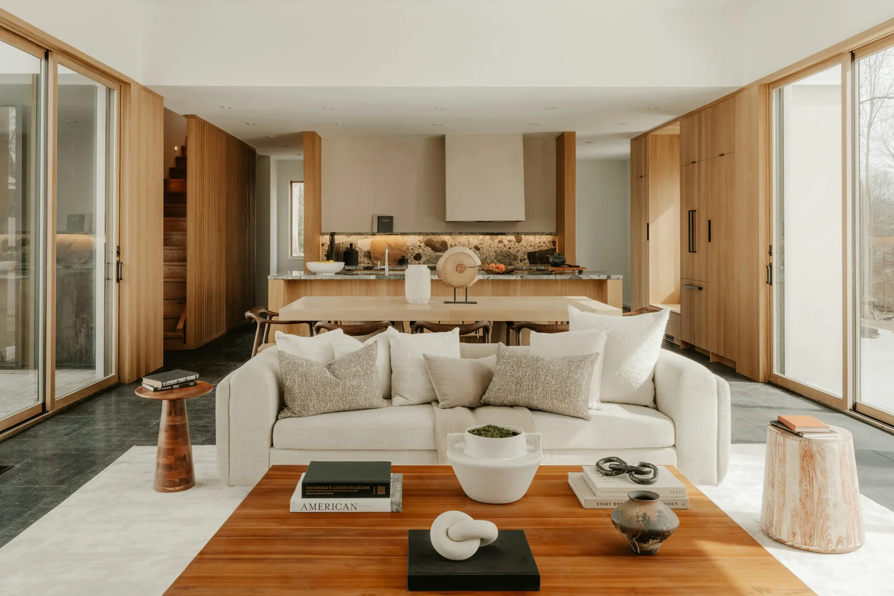 A Wren House living room: a pale sofa, a walnut coffee table and wood-framed windows
